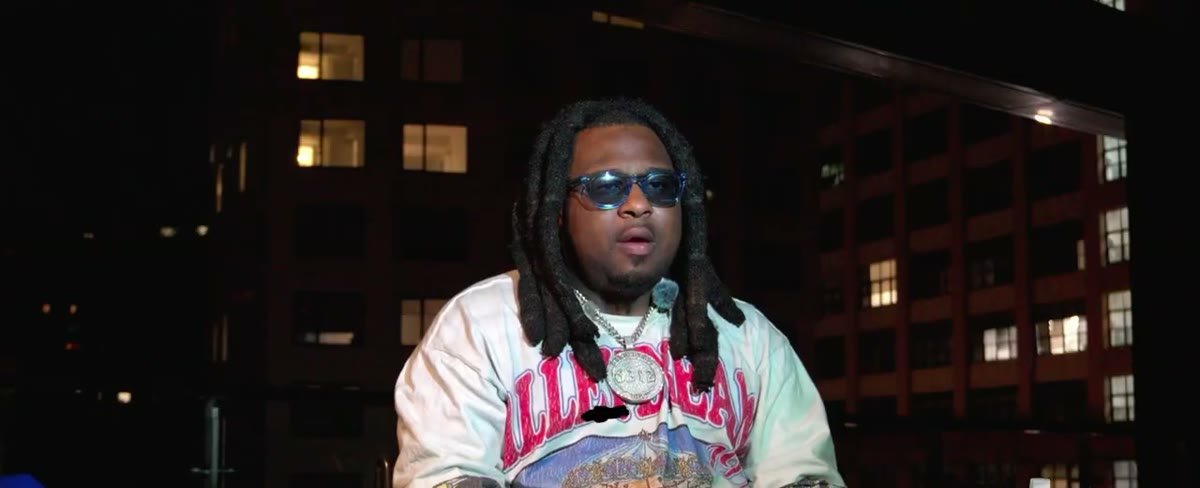 Dumar 1K on a rooftop at night during an interview